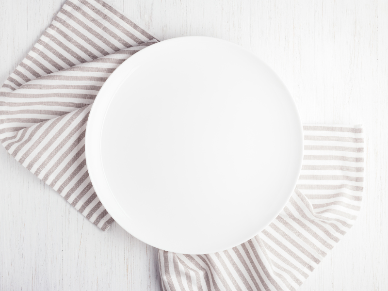 White Plate on Table with Grey and White Striped Napkin