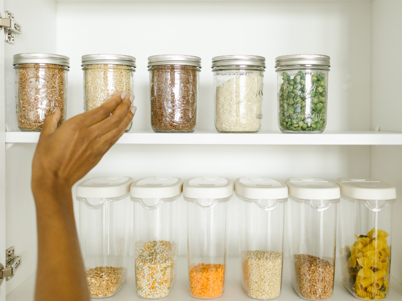 Woman reaching for pantry jar