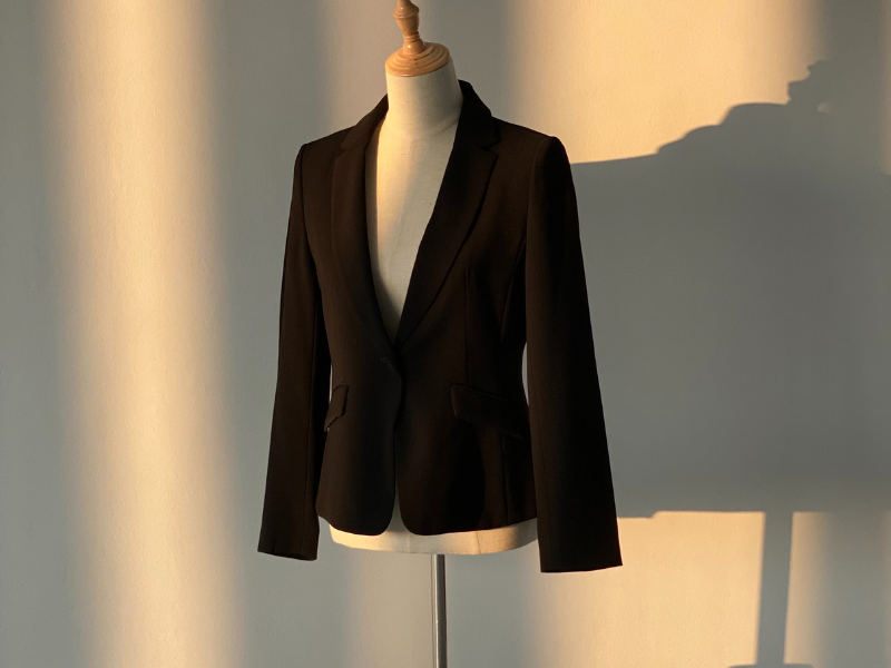 a mannequin with a woman's black blazer